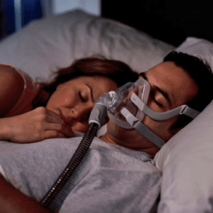 Hombre durmiendo con su pareja mientras lleva puesta la mascarilla facial airfit f20